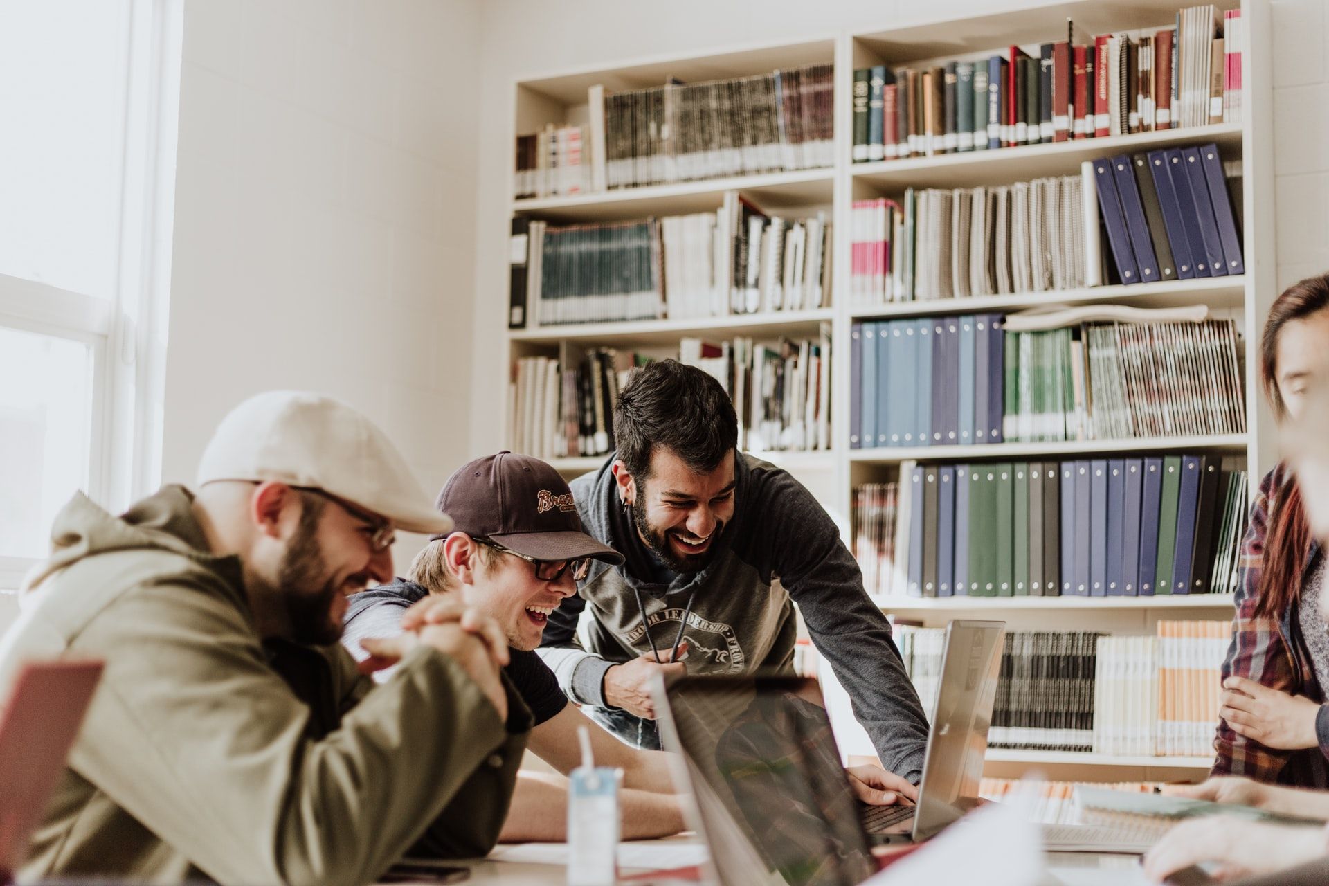 A team of young employees working and laughing together.