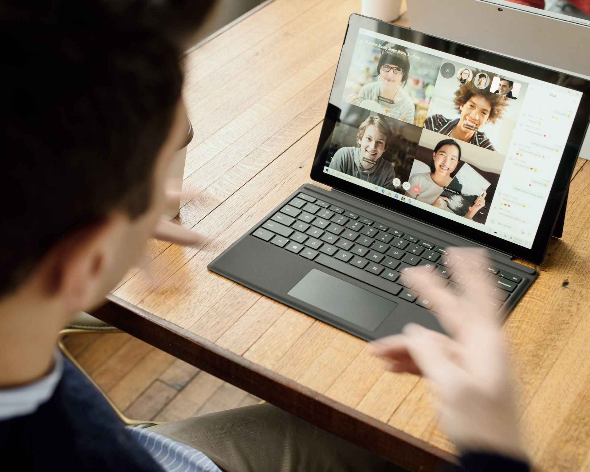 This picture shows a group video call between remote employees taking place.